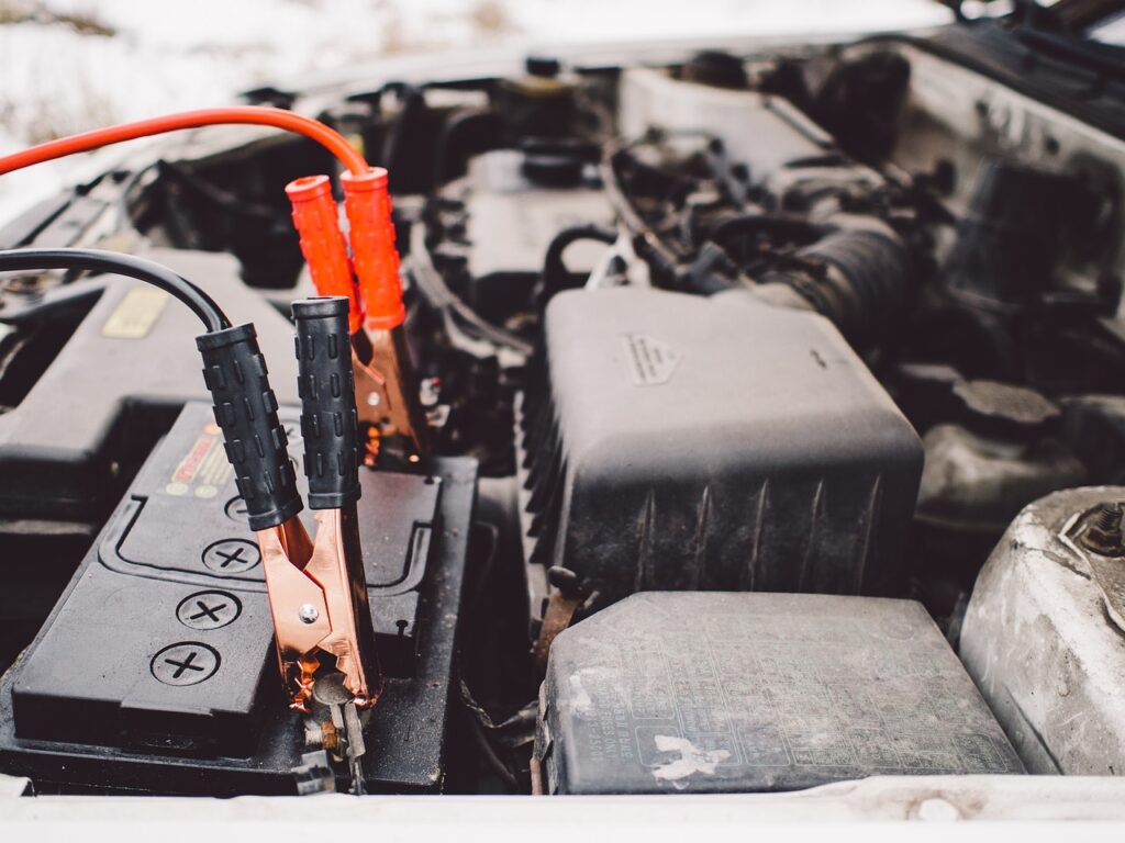 Car Battery with Jumper Cables, Image for article about tips for maitaining your car's battery life.