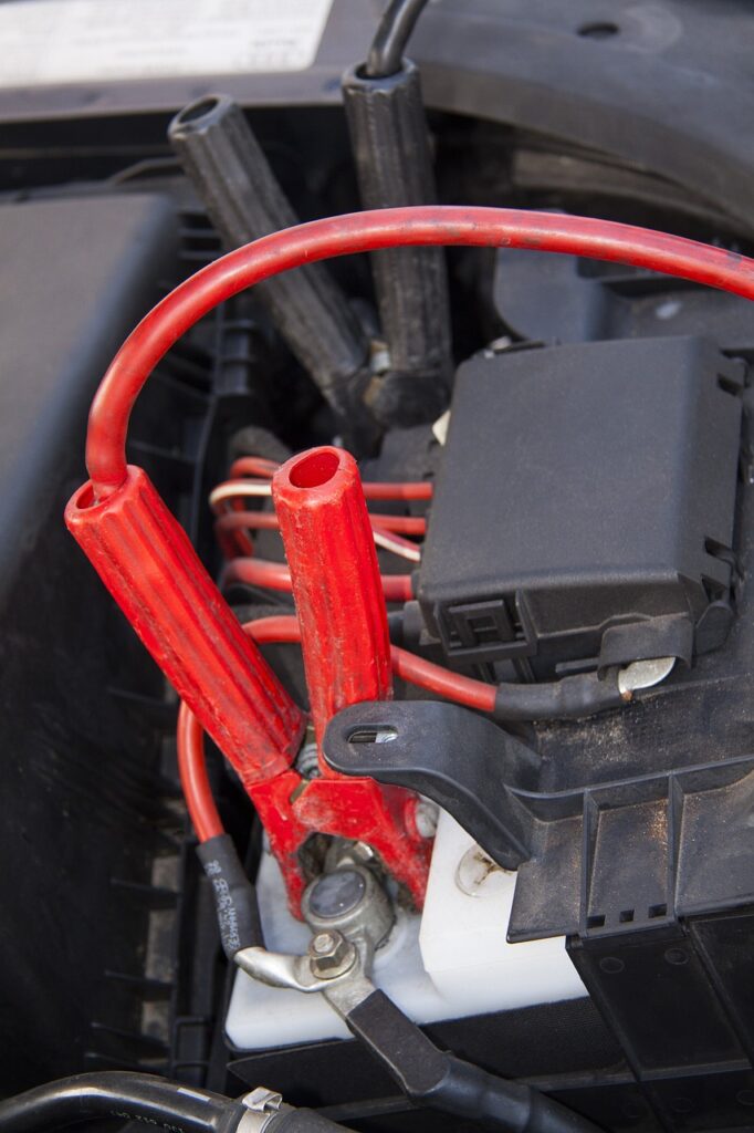 This is an image of Car battery with Jumper Cables attached for article The Complete Guide: How to Jump-Start a Dead Car Battery Safely and Effectively