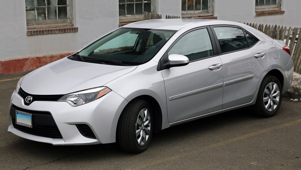 An image of white corolla sedan for the article top cars under $10000